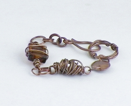 Disk and wire wrapped glass bracelet 